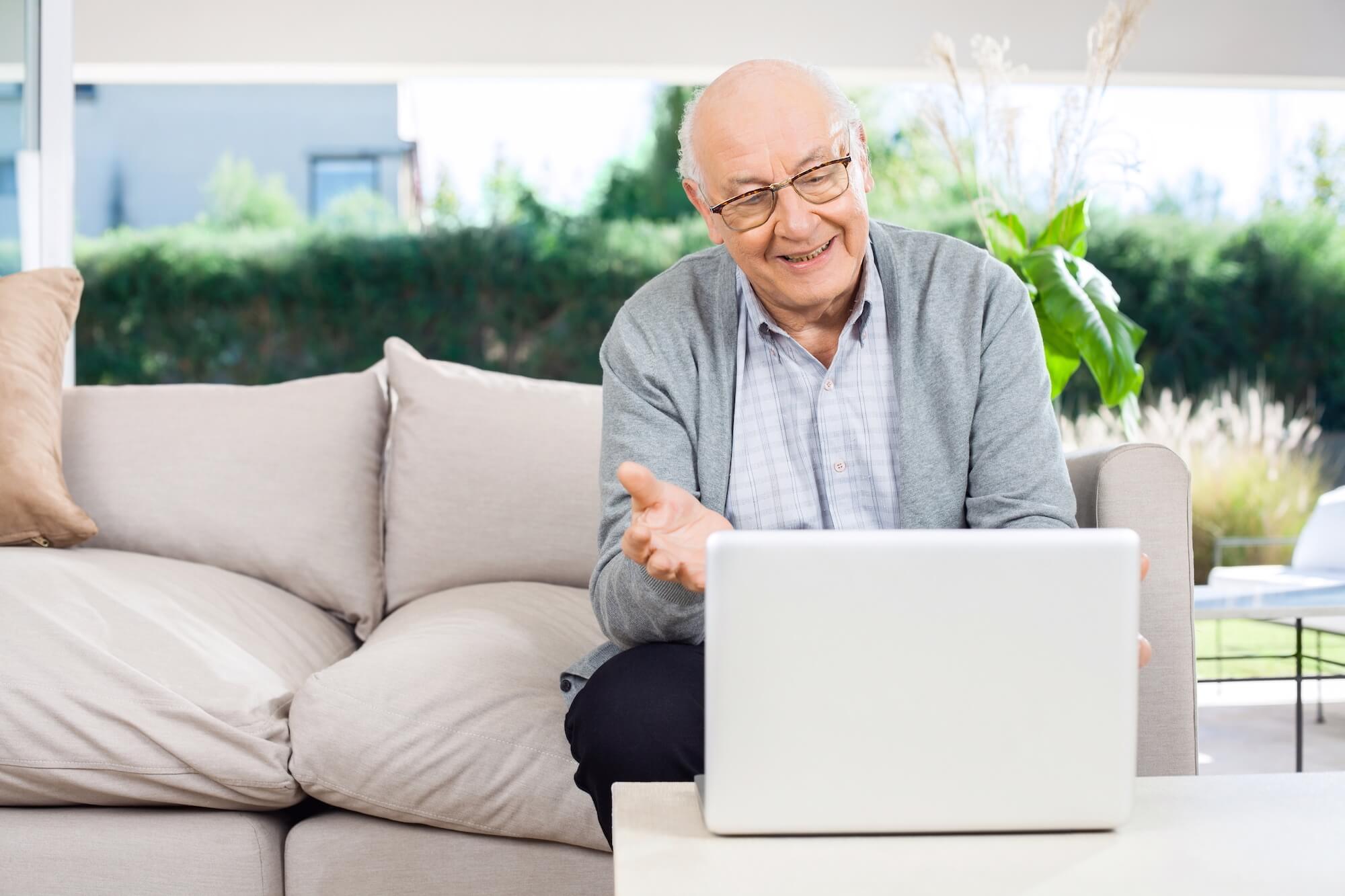 Elderly man using his laptop to check up on his health portal
