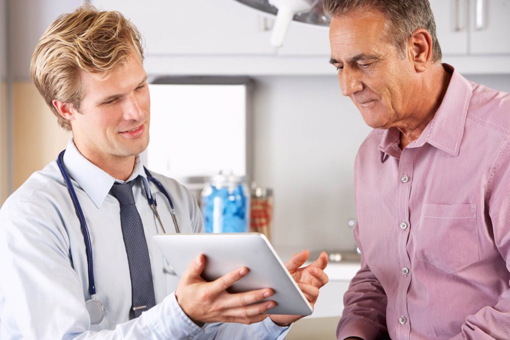 Doctor showing patient his medical records on a tablet